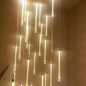 Elegant Ferraro pendants in Clear glass with Gold particles - light on Glow. High Ceiling Design Idea