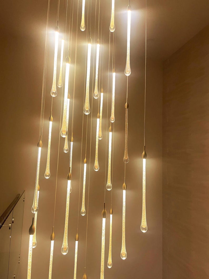 Elegant Ferraro pendants in Clear glass with Gold particles - light on Glow. High Ceiling Design Idea
