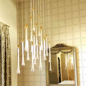 Elegant clustered Ferraro Chandelier in dining room. High Ceiling Design Idea