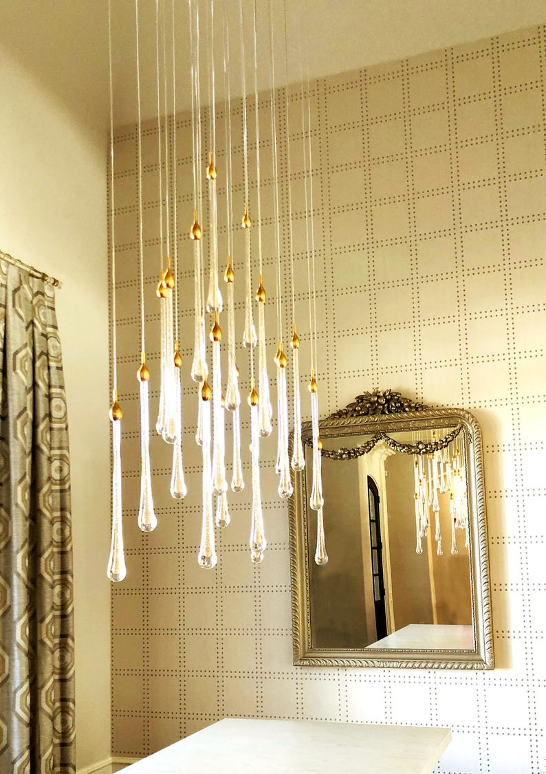Elegant clustered Ferraro Chandelier in dining room. High Ceiling Design Idea