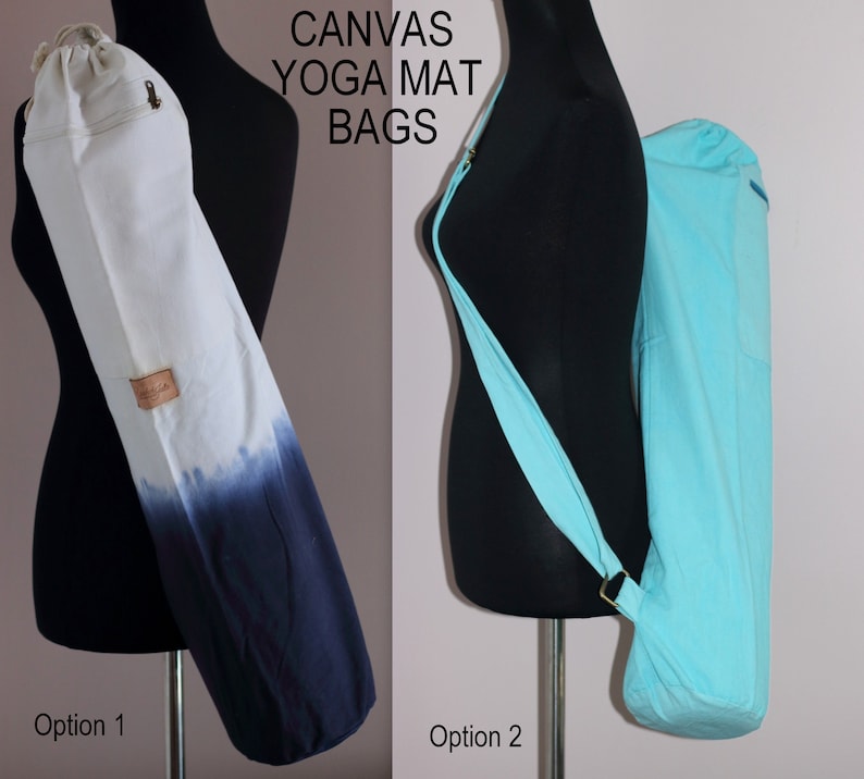 May include: Two canvas yoga mat bags. The bag on the left is white with a blue ombre design. The bag on the right is a solid light blue. Both bags have a long strap for carrying over the shoulder.