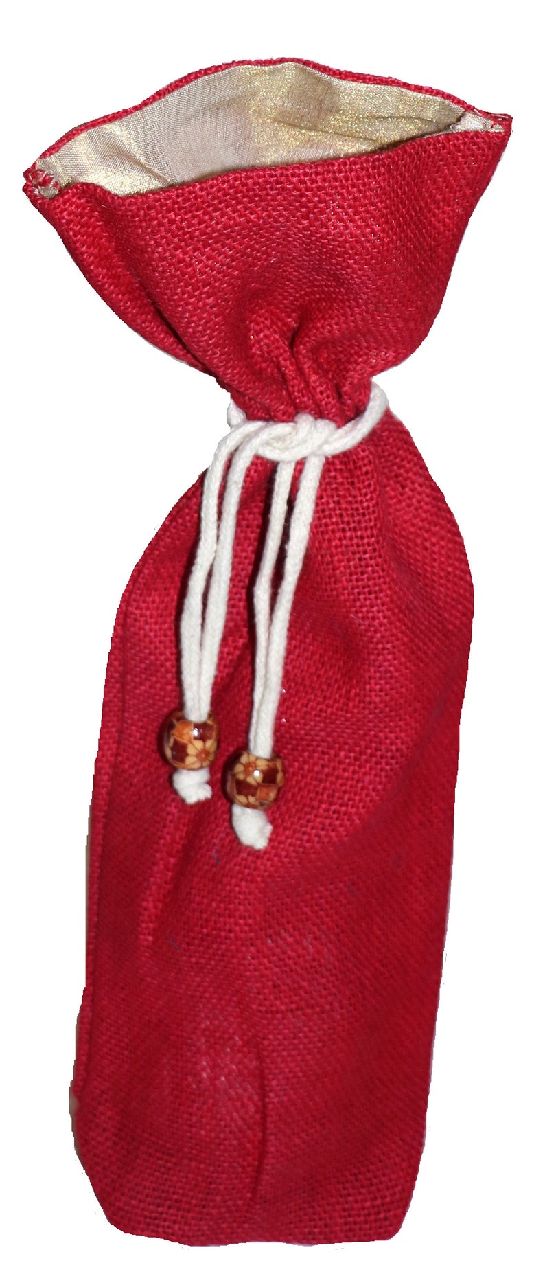 May include: A red burlap drawstring bag with white cords and wooden beads. The bag is lined with a gold fabric.