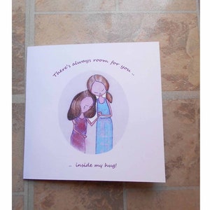 May include: A white greeting card featuring an illustration of two figures in an embrace. The card has the text: "There's always room for you... inside my hug!" The figures are in a circle.