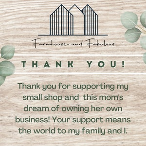 May include: A thank you card with a woodgrain background and green eucalyptus leaves on either side. The card features a black and white illustration of two houses with the text "Farmhouse and Fabulous" above the text "THANK YOU!" and a message of gratitude for supporting a small shop.