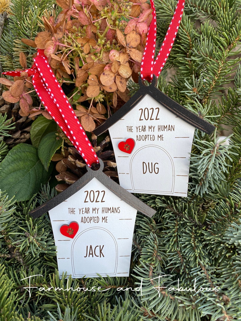 May include: Two wooden dog house ornaments with red hearts and the text "2022 The Year My Human(s) Adopted Me" and the names "Jack" and "Dug".