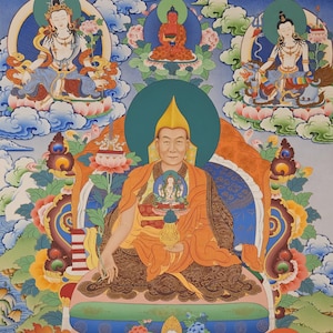 May include: A vibrant Tibetan thangka painting featuring a central figure in orange robes, seated on a throne. Surrounding the central figure are other deities and figures, with intricate details and bright colors. The artwork is rich in symbolism and cultural significance.