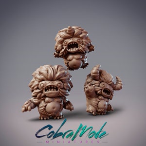 May include: Three small, brown, furry, fantasy creature figurines with toothy grins. The creatures have horns and are posed in different positions. The figurines are made of a textured material and are painted in a brown color.