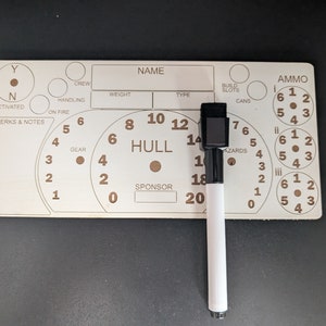 May include: A wooden game board with a dial for hull points, a section for crew, gear, and hazards, and a section for ammo. The board is marked with numbers from 0 to 20, and the ammo section has three circles with numbers 1 to 6.