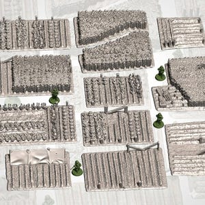 May include: A collection of grey, unpainted miniature tabletop gaming terrain pieces representing various agricultural field plots, including rows of crops, tilled soil, and fenced sections, accompanied by small green soldier figurines.