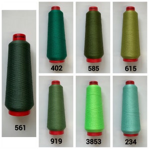 May include: Six spools of Gutermann thread in various colours, including green, dark green, light green, lime green, and blue. Each spool has a red label with the Gutermann logo and a number: 402, 585, 615, 561, 919, 3853, and 234.