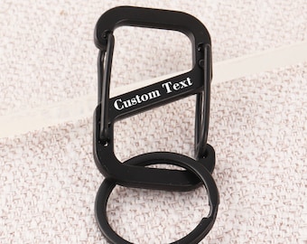 May include: Black metal carabiner keychain with a round ring and the text "Custom Text" engraved on the side.