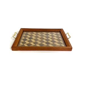 May include: A wooden serving tray with brass handles. The tray has a geometric pattern of inlaid wood.