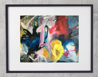 May include: Abstract art print in a black frame. The artwork features a vibrant mix of colors, including red, yellow, blue, and pink, with bold brushstrokes. The framed art hangs above a black leather sofa with silver legs, set against a concrete wall.