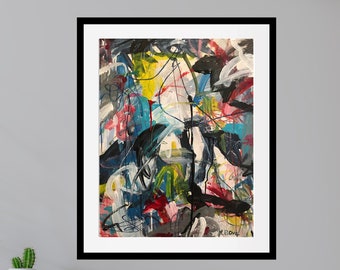 May include: Abstract art print in a black frame. The artwork features a vibrant mix of colors, including yellow, blue, red, and black, with dynamic brushstrokes and lines. The piece is mounted on a white mat, creating a striking contrast.