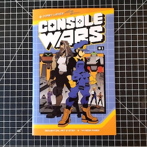 May include: A comic book cover with a blue, yellow, and orange color scheme. The title is "CONSOLE WARS #1" with a pixelated font. The cover features a character in a blue jumpsuit and a character with a beard and a white shirt.