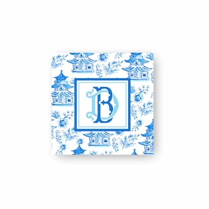 May include: A square with a blue and white pattern featuring small blue pagodas and flowers on a white background. The centre of the square features a blue and white monogram "B".