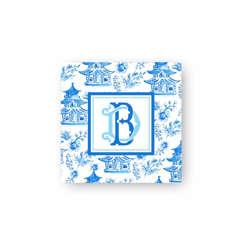 May include: A square with a blue and white pattern featuring small blue pagodas and flowers on a white background. The centre of the square features a blue and white monogram "B".