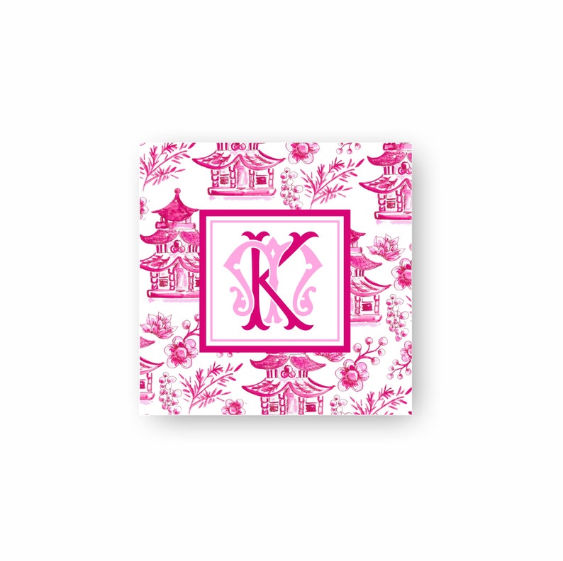 May include: A square card with a pink and white pattern featuring pagodas and a pink monogram "K" in the centre.
