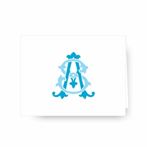 May include: A blue and light blue monogram with the letters "SA" in a decorative, ornate font.