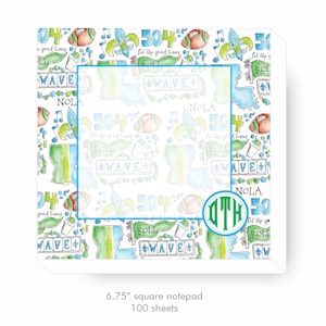 May include: A white notepad with a green, blue, and brown pattern featuring footballs, musical notes, and the text "504 Let the good times roll" and "NOLA". The notepad has a green monogram "DTH" in a circle. The notepad is 6.75 inches square and has 100 sheets.