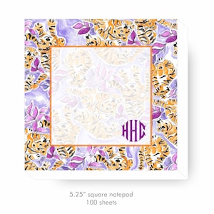 May include: A notepad with a purple and white background featuring a repeating pattern of orange tigers. The notepad has a white border and a monogram in the center that reads "HHC". The notepad is 5.25 inches square and has 100 sheets.
