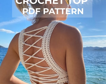 May include: White crochet top with a criss-cross back design. The top is shown on a model against a blue sky and ocean background. The text "CROCHET TOP PDF PATTERN" is displayed on the image.