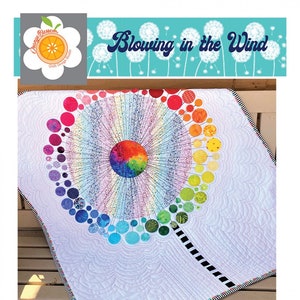 May include: A colorful applique quilt pattern featuring a dandelion with a rainbow center and a white background. The quilt is 36 inches by 40 inches. The pattern is called "Blowing in the Wind" and is designed by Laura L. Strickland.