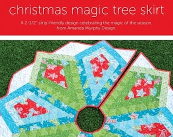 May include: A quilted Christmas tree skirt featuring a star-shaped pattern in red, green, and light blue fabrics with holiday motifs. The design includes text stating: christmas magic tree skirt, A 2-1/2 inch strip-friendly design, and 2-1/2 inch strip-friendly.