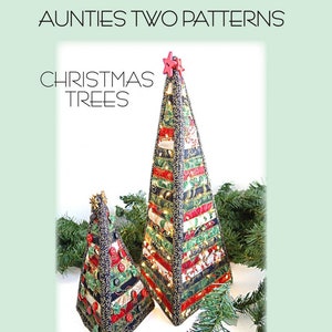 May include: A pattern for making two Christmas trees from fabric strips. The trees are decorated with red, green, and gold fabric. The larger tree is 16 inches by 7 inches and the smaller tree is 8 1/4 inches by 5 inches. The pattern is called "Jingle Pops" and is copyright 2015. The pattern number is AT 276.