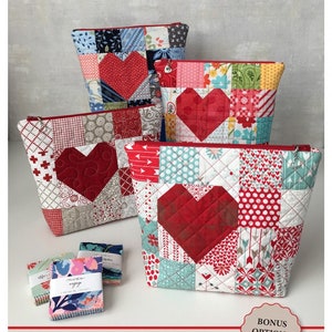 May include: Four red and white patchwork heart-shaped zipper pouches with a red zipper. The pouches are stacked on top of each other. The text "Be Mine Heart Zipper Pouch" is written below the pouches. The text "Bodobo Bags by Ticklegrass Designs" is written below the text "Be Mine Heart Zipper Pouch".