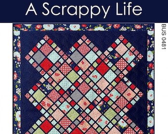 May include: A quilt pattern titled "A Scrappy Life" with a navy blue background and a repeating diamond pattern in red, pink, green, and gray squares. The quilt is bordered with a floral pattern. The pattern includes four sizes.