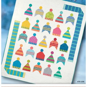 May include: A quilting pattern featuring a colorful design of hats and scarves. The pattern is titled "Hat Hat Hooray!" and is from Atkinson Designs. The pattern number is ATK-206.