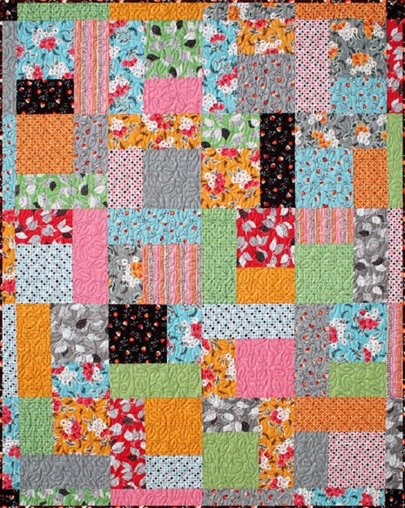 May include: A patchwork quilt with a variety of colorful fabrics, including floral prints, polka dots, stripes, and geometric patterns. The quilt is made up of squares and rectangles of different sizes, creating a visually interesting and textured design.