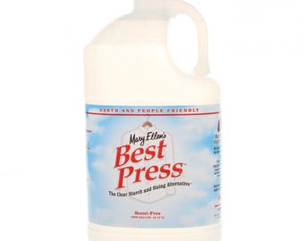May include: A white plastic gallon jug of Mary Ellen's Best Press Scent-Free laundry starch and sizing alternative. The label is blue and red with white text. The label says "Earth and People Friendly" and "The Clear Starch and Sizing Alternative".