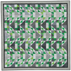 May include: A quilt with a geometric pattern of green and grey triangles. The quilt is made up of many smaller squares, each with a different pattern.