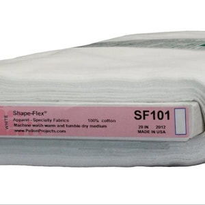 May include: A roll of white Shape-Flex fabric, 20 inches wide, made of 100% cotton. The label includes the product code SF101 and the manufacturer's website. The fabric is designed for apparel and specialty fabrics.