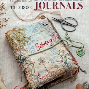 May include: A book titled "Daydream Journals" by Tilly Rose, with the subtitle "Memories, Ideas & Inspiration in Stitch, Cloth & Thread". The book cover features a handmade journal with a floral design and the word "Gatherings" embroidered on the front.
