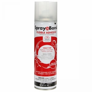 May include: A white aerosol can of Spray n Bond fusible adhesive with a red label featuring white text and swirling graphic patterns. The label includes the text Spray n Bond, Fusible Adhesive, Iron-On, and Net Weight 6.9 oz, with a clear plastic cap.
