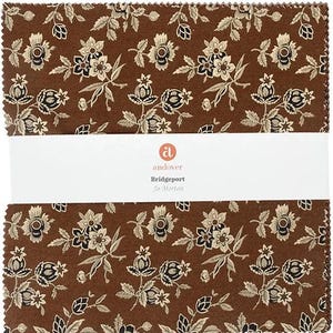 May include: A stack of fabric squares with a repeating floral pattern in brown, cream, and black. The fabric features stylized flowers and leaves. The brand name "andover" and the collection name "Bridgeport" are printed on a white label.