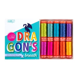 May include: A set of 10 spools of Aurifil thread in a rainbow of colors, labeled "Dragon's Breath" and "Tula Pink". The spools are arranged in a box with a dragon illustration.