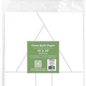 May include: A package of 42 white 10-inch by 10-inch quilt paper squares for making quilt blocks. The package has a green label with the text "Trees Quilt Paper by Lori Holt of Bee in my Bonnet" and a QR code.