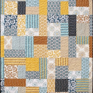 May include: A patchwork quilt with a variety of geometric and floral patterns in shades of blue, yellow, brown, and white.