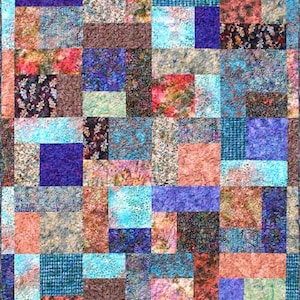 May include: A patchwork quilt with a variety of colorful fabrics, including blue, purple, pink, brown, and green. The quilt is made up of squares and rectangles of different sizes.