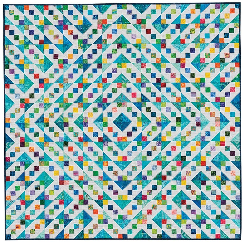 May include: A colourful quilt with a geometric pattern of squares and triangles. The quilt is made with a variety of fabrics in shades of blue, green, yellow, and white.