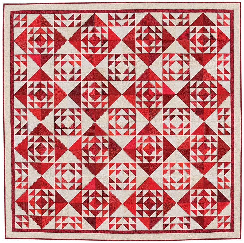 May include: A red and white quilt with a geometric pattern. The quilt is made up of squares and triangles, and the colours are arranged in a repeating pattern.