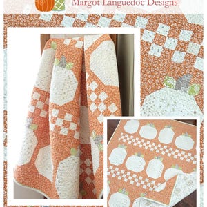 May include: A quilt with a pumpkin theme, featuring white pumpkins on an orange background. The quilt has a patchwork design with the text "Log Cabin Pumpkins" and the website address www.thepatternbasket.com.