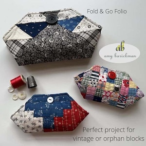 May include: Three quilted fabric pouches in different patterns and colors. The pouches are folded and have buttons. The text "Fold & Go Folio" and "amy barickman" is visible. The text "Perfect project for vintage or orphan blocks" is also visible.