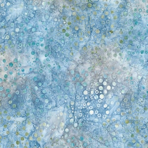 May include: Abstract fabric with a watercolor effect. The design features a blend of blue, white, and gray hues, with scattered circles in various sizes and shades of blue, green, and white. The fabric has a mottled appearance.