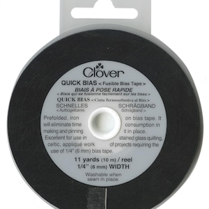 May include: A spool of black fusible bias tape, 1/4 inch wide, by Clover. It is 11 yards long and washable when sewn in place.  The label reads "Quick Bias Fusible Bias Tape, Biais à Pose Rapide, Quick Bias,  Schnelles Schrägband".