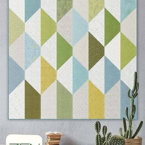 May include: Geometric abstract art quilt with a repeating pattern of triangles in shades of blue, green, yellow, and white. The quilt has a textured appearance. The text "ZEN CHIC" and "COSMO" are visible.